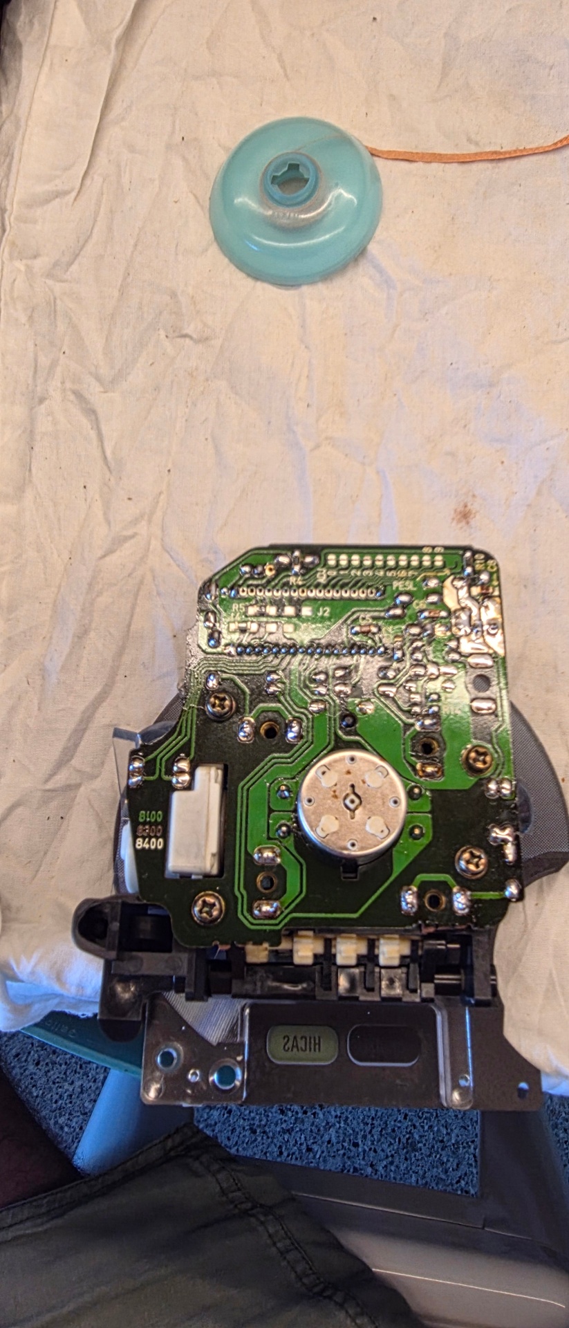 Rear of Nissan cluster PCB showing solder joints and stepper motor mount